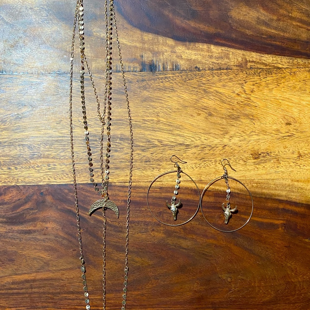 Gold statement necklace and cow skull earrings